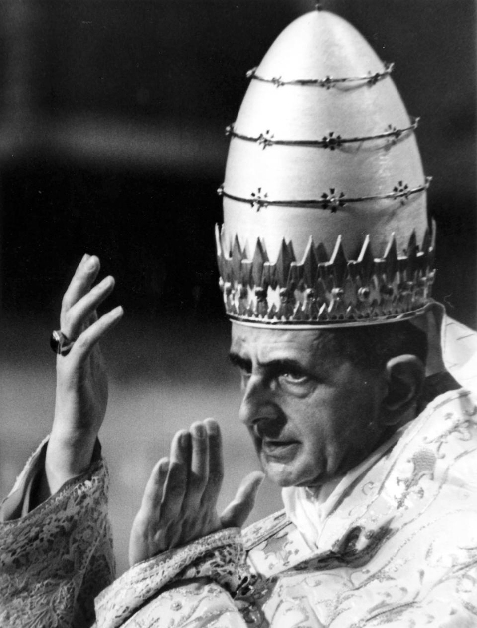 FILE - In this file photo taken on June 30, 1964, Pope Paul VI, wearing full Pontific robes and the Papal "Tiara" or triple crown, lifts both hands to answer to a cheering crowd, as he is carried on his portable throne out of saint Peter's Basilica, after having attended a solemn Pontific mass, marking the first anniversary of his coronation. Pope Francis has approved a miracle credited to the intercession of Paul VI and set the date for the late pontiff's beatification for Oct. 19, the Vatican said Saturday. Francis had authorized the beatification, the last formal step before possible sainthood, a day earlier, the Vatican said. Paul VI, who reigned as pontiff from 1963-1978, made landmark progress in improving Catholics' relationship with other Christians. His papacy is also remembered by his decision, after years of study, to ban contraception for Catholics, in a 1968 encyclical, "Humanae Vitae" ("of human life"). (AP Photo/Girolamo Di Majo)