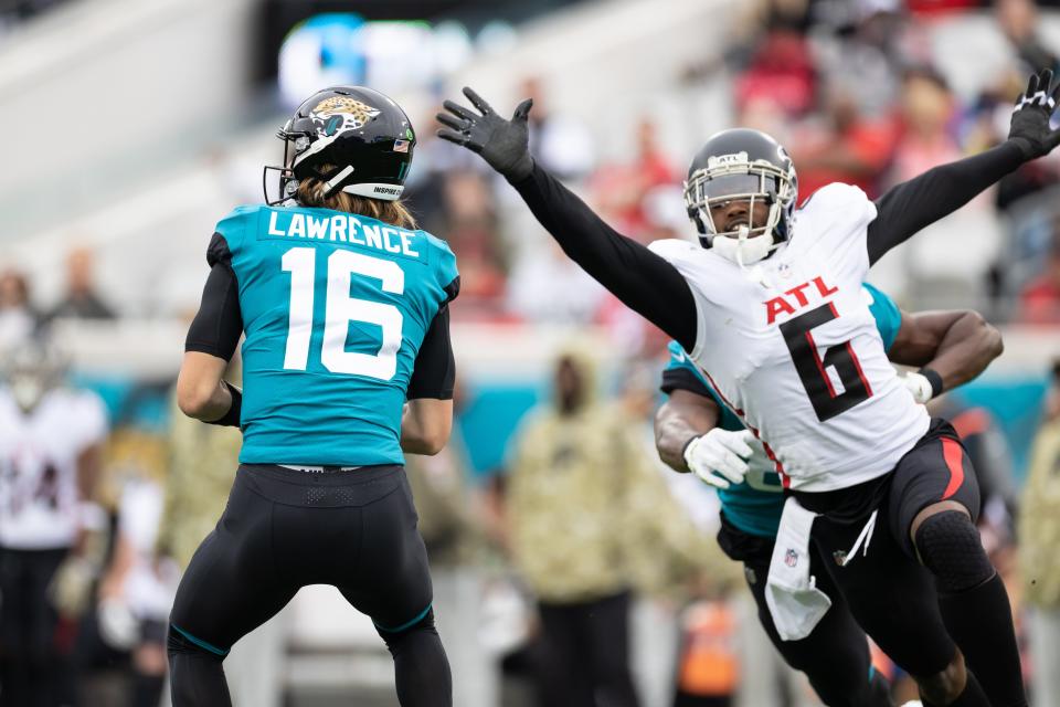 Atlanta Falcons linebacker Dante Fowler Jr. (6) attempts to tackle Jacksonville Jaguars quarterback Trevor Lawrence (16) at TIAA Bank Field on Nov. 28, 2021.