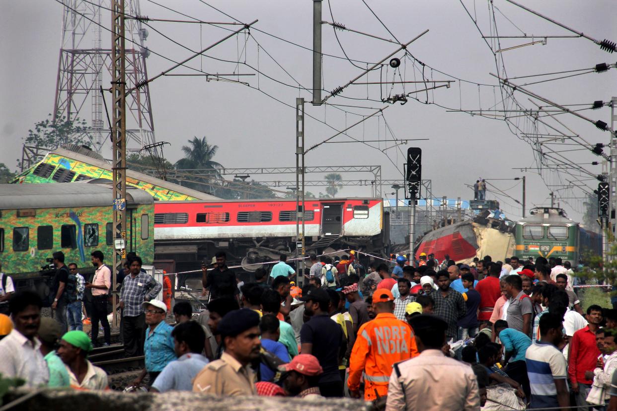 Residents look alongside the grounded trains (Copyright 2023 The Associated Press. All rights reserved.)