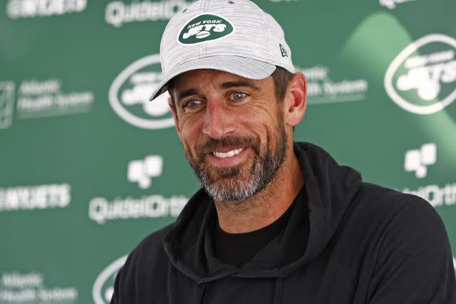 <p>Rich Schultz/Getty</p> Quarterback Aaron Rodgers #8 of the New York Jets talks to reporters after training camp at Atlantic Health Jets Training Center on July 26, 2023 in Florham Park, New Jersey.