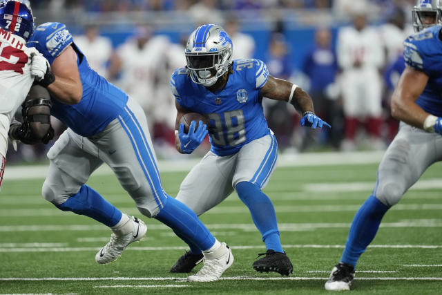 Detroit Lions quarterback Adrian Martinez (18) keeps the ball during the  second half of an NFL