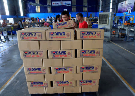 Voluneteers stack boxex of relief goods which will be distributed to the victims of Super Typhoon Haima, local name Lawin, at a warehouse in Pasay city, metro Manila, Philippines October 20, 2016. REUTERS/Romeo Ranoco