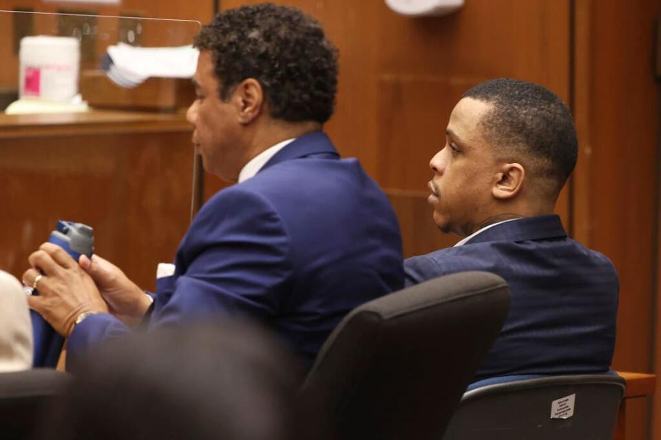 Defendant Eric Holder, right, and his attorney Aaron Jansen listen during opening statements in Holder’s murder trial on June 15, 2022 at Los Angeles Superior Court in Los Angeles. Holder, 32, faces one count of first degree-murder and two counts of attempted first-degree murder for the killing the Grammy Award-winning rapper Nipsey Hussle outside his clothing store three years ago. (Frederick M. Brown/Daily Mail.com via AP, Pool)