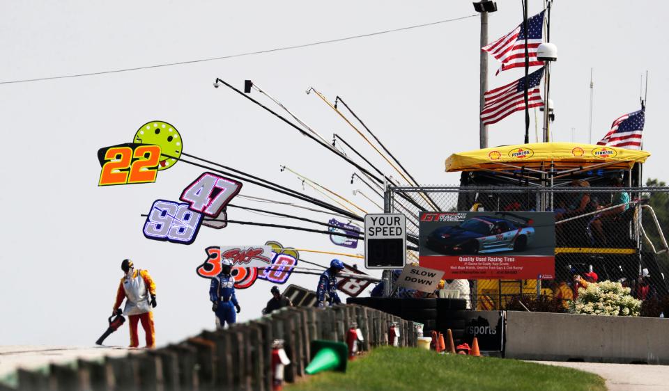 Signs direct drivers to their pits during NASCAR weekend last year.