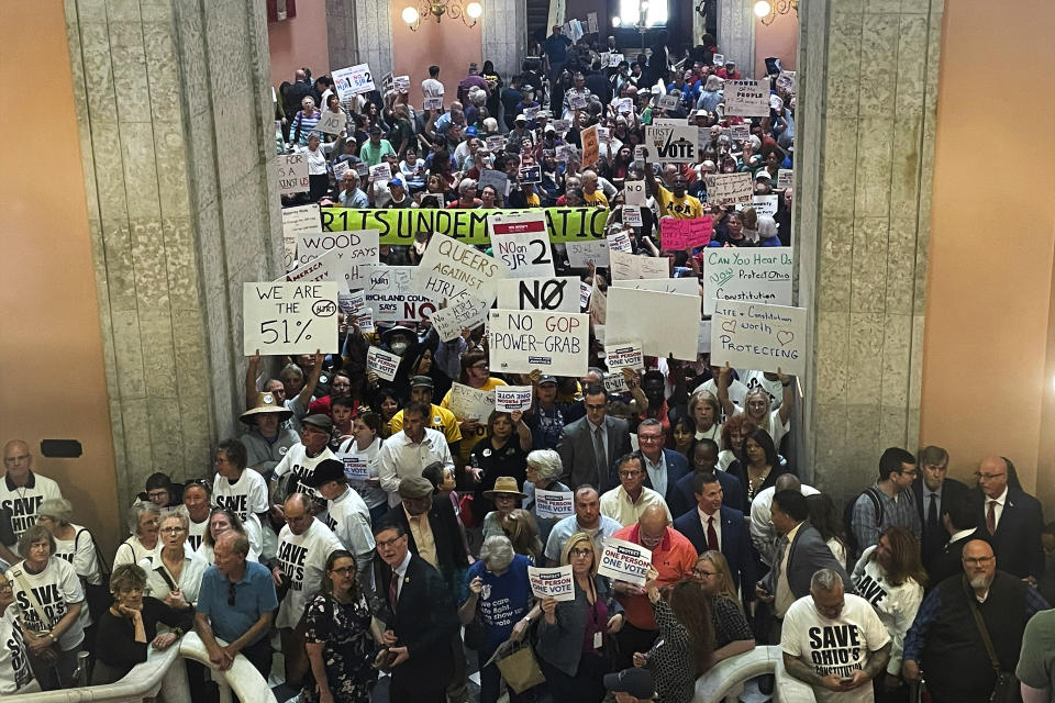 Supporters and opponents of a GOP-backed measure that would make it harder to amend the Ohio constitution packed the statehouse rotunda Wednesday, May 10, 2023, in Columbus, Ohio ahead of the politically fractured Ohio House's vote. At stake is a citizen-led amendment to grant abortion access in Ohio, which Republicans seek to thwart by raising the threshold to change the state's constitution from 50% plus one to 60%. (AP Photo/Samantha Hendrickson)