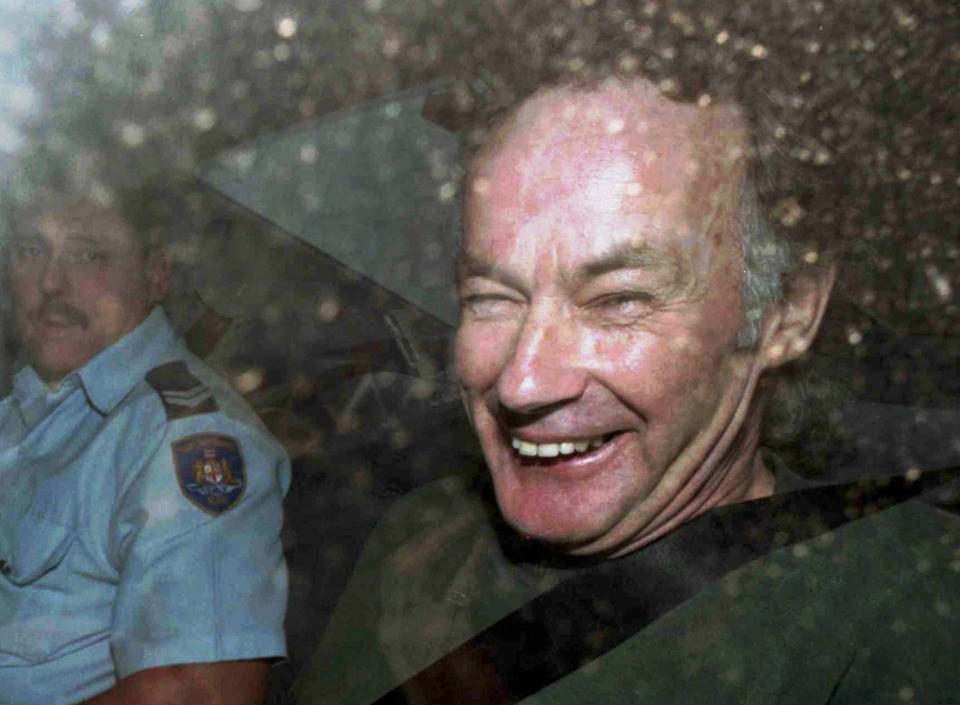 Ivan Milat pictured in 1997 smiling to cameras following a court appearance. Source: AAP