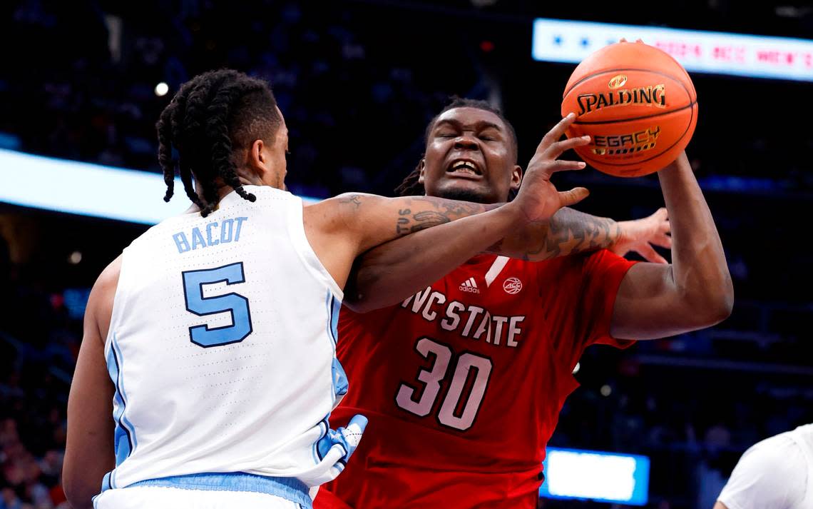 N.C. State’s DJ Burns Jr. (30) is fouled by North Carolina’s Armando Bacot (5) during the second half N.C. State’s 84-76 victory over UNC in the championship game of the 2024 ACC Men’s Basketball Tournament at Capital One Arena in Washington, D.C., Saturday, March 16, 2024.