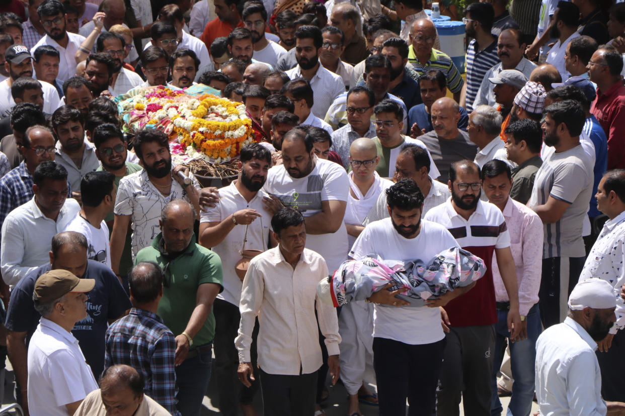 People carry bodies of victims of an accident, when a structure built over an old temple well collapsed Thursday as a large crowd of devotees gathered for the Ram Navami Hindu festival, in Indore, India, Friday, March 31, 2023. Thirty-five bodies have been found inside a well at a Hindu temple in central India after dozens of people fell into the muddy water when the well's cover collapsed. (AP Photo)