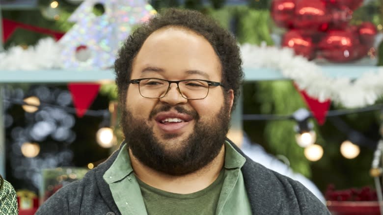 Zach Cherry smiling on set of The Great American Baking Show 