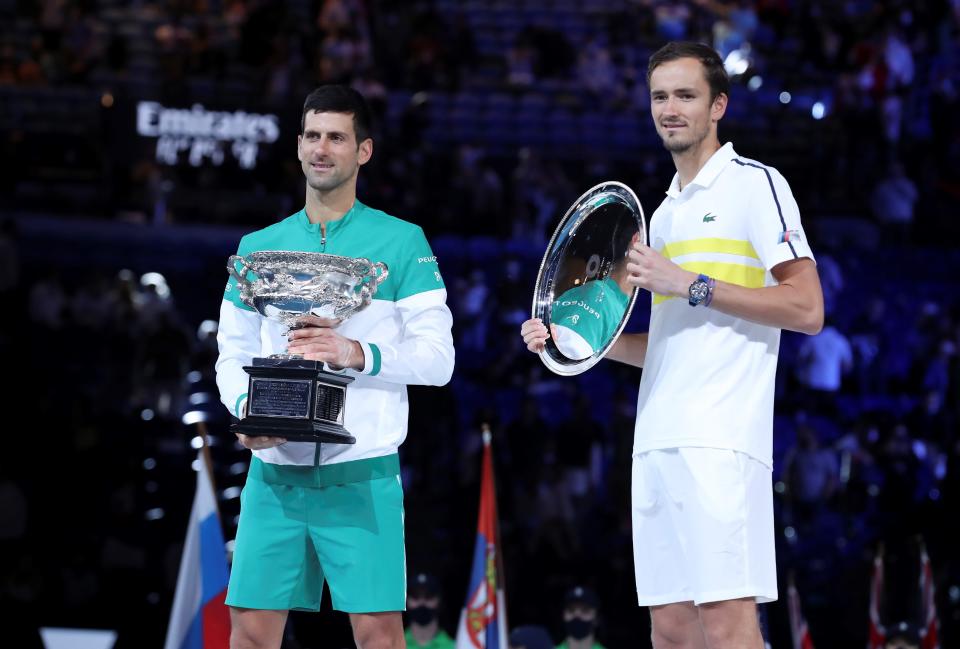 Novak Djokovic (pictured left) and Daniil Medvedev (pictured right) pose for photos after their men's singles final at Australian Open in Melbourne Park in Melbourne, Australia, Feb. 21, 2021.