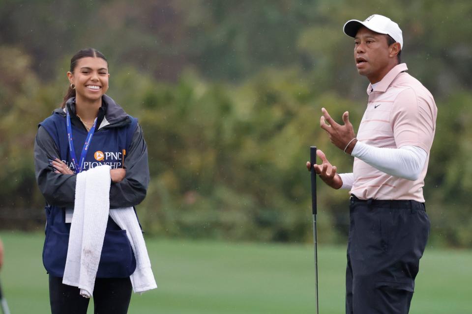 Dec 16, 2023; Orlando, Florida, USA; Tiger Woods reacts with his daughter Sam Woods (left) after missing a putt on the fifth green during the PNC Championship at The Ritz-Carlton Golf Club. Mandatory Credit: Reinhold Matay-USA TODAY Sports