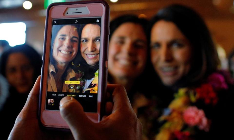 Gabbard poses for a photograph with a diner at the Green Elephant in Portsmouth, New Hampshire, 17 February 2019.