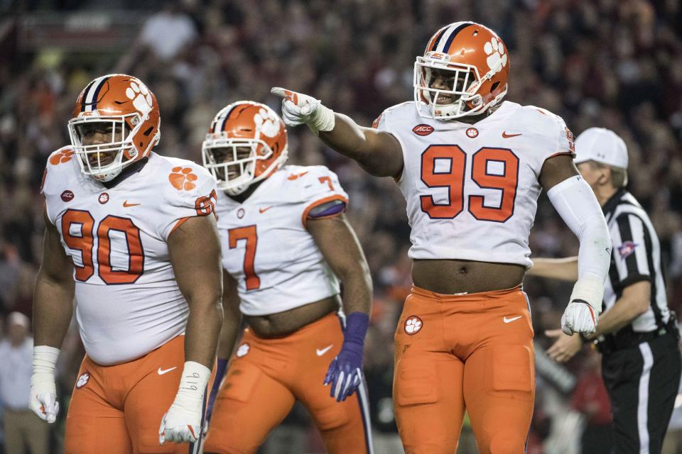 Clemson defensive end Clelin Ferrell (99), Dexter Lawrence (90) and Austin Bryant (7) react after a sack during the first half of an NCAA college football game against South Carolina on Saturday, Nov. 25, 2017, in Columbia, S.C. Clemson defeated South Carolina 34-10. (AP Photo/Sean Rayford)