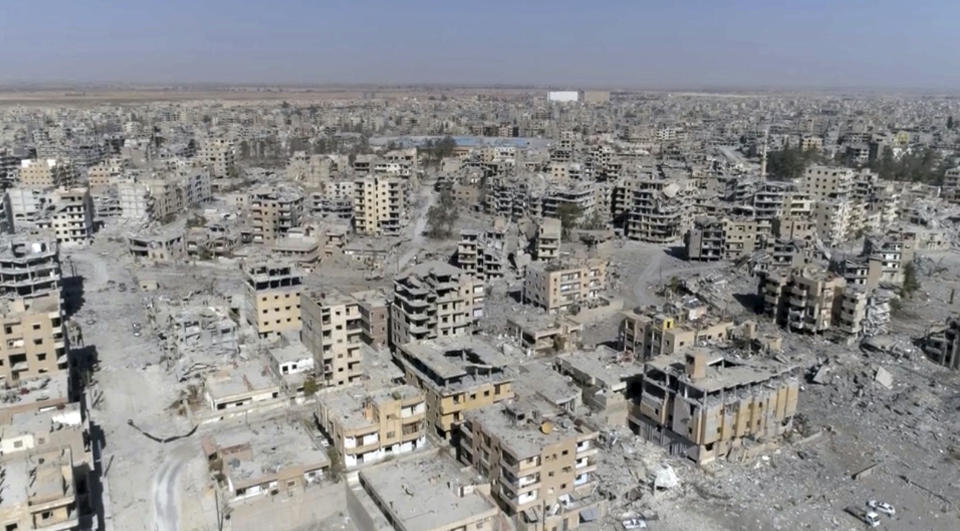 FILE - In this Thursday, Oct. 19, 2017 file photo, a frame grab made from drone video shows damaged buildings in Raqqa, Syria.(AP Photo/Gabriel Chaim, File)