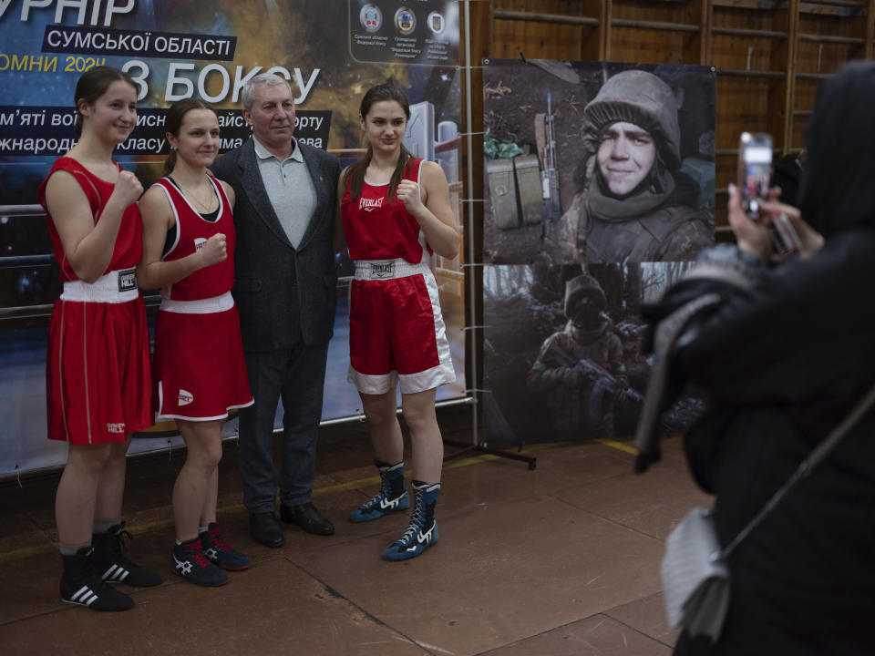 Boxers pose for a photo during the official opening of boxing tournament in honor of Maksym Halinichev, who was killed during fighting with Russian forces in March 2023, in Romny, Sumy region, Ukraine on Saturday, Feb. 3, 2024. (AP Photo/Evgeniy Maloletka)