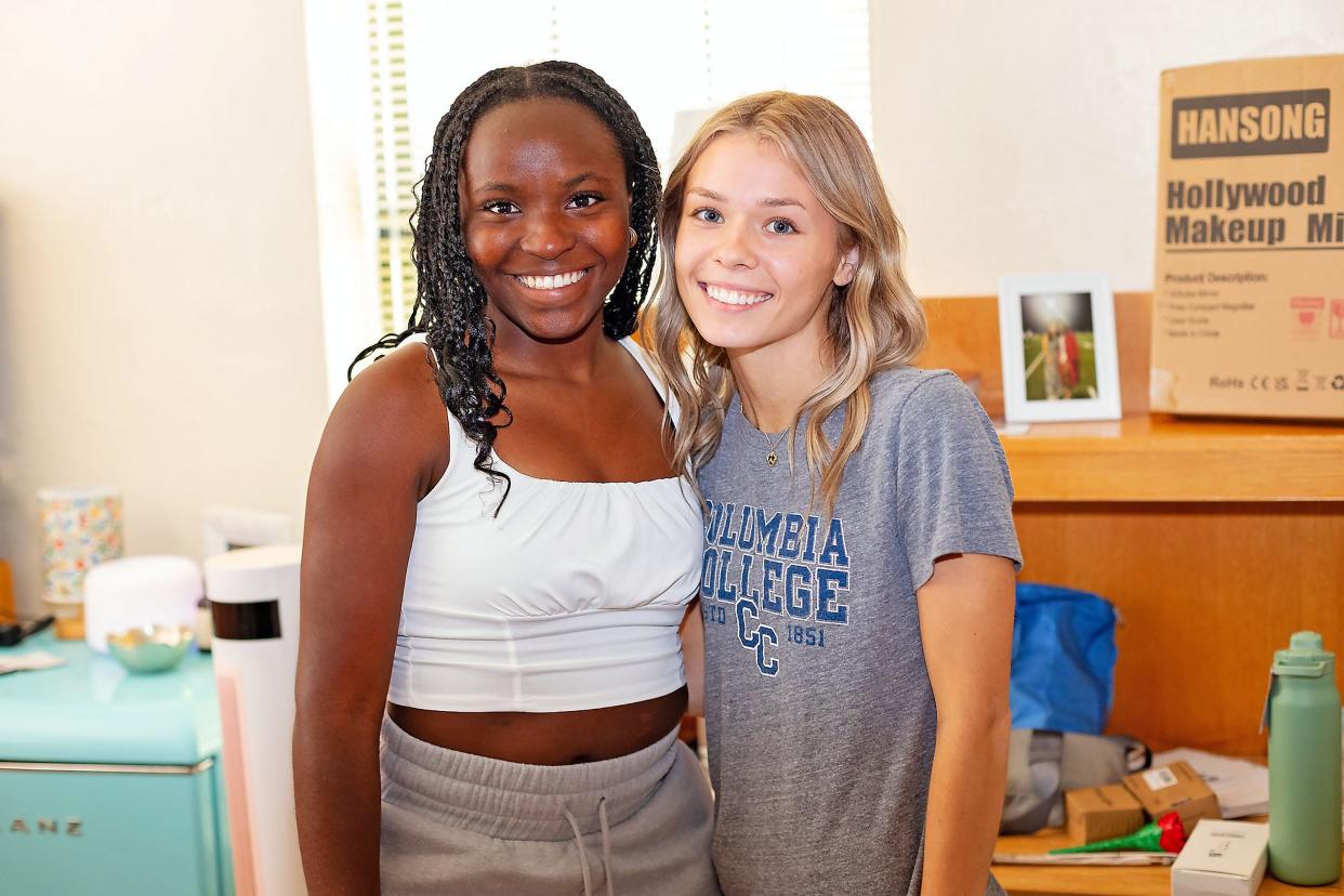 Freshmen Adrianna McMath, from left, and McKenna Shelton move into New Hall on Wednesday, Aug. 21, on the main campus of Columbia College in Columbia, Missouri.