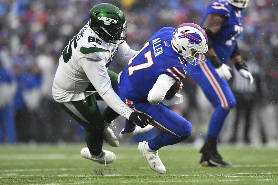 Buffalo Bills quarterback Josh Allen (17) is brought down by New York Jets defensive tackle Quinnen Williams during the first half of an NFL football game, Sunday, Dec. 11, 2022, in Orchard Park, N.Y. (AP Photo/Adrian Kraus)