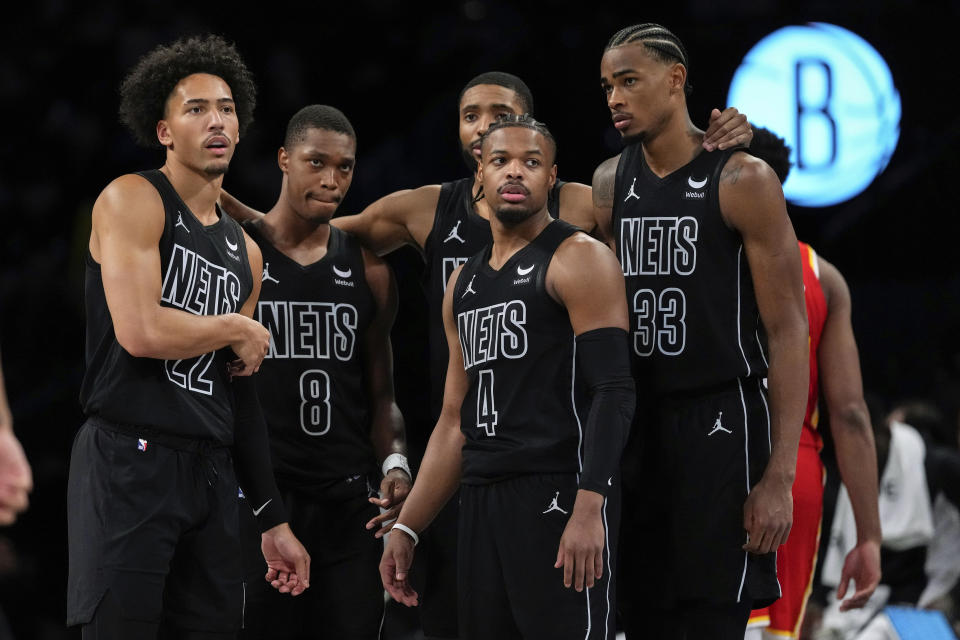 Brooklyn Nets' Jalen Wilson (22) huddles with teammates Lonnie Walker IV (8), Dennis Smith Jr. (4), Nic Claxton (33) and Mikal Bridges during the second half of an NBA basketball game against the Atlanta Hawks, Thursday, Feb. 29, 2024, in New York. The Nets won 124-97. (AP Photo/Frank Franklin II)