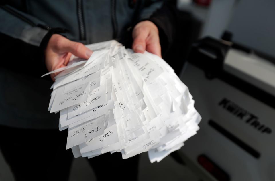 Ripon resident Whit Meza shows her stack of receipts she's kept from visiting every Kwik Trip location in Wisconsin store on an 11-day motorcycle trip.