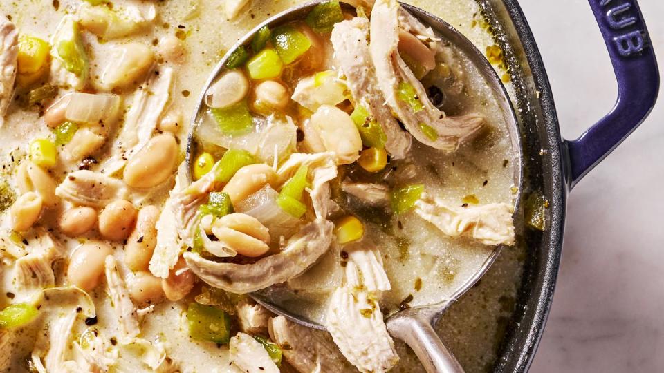 white chicken chili with cilantro, chips, sour cream and avocado