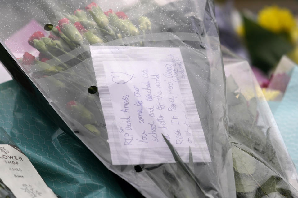 A note is seen on a floral tribute near the site where a member of Parliament was killed on Friday, in Leigh-on-Sea, Essex, England, Saturday, Oct. 16, 2021. David Amess, a long-serving member of Parliament was stabbed to death during a meeting with constituents at a church in Leigh-on-Sea on Friday, in what police said was a terrorist incident. A 25-year-old British man is in custody. (AP Photo/Alberto Pezzali)