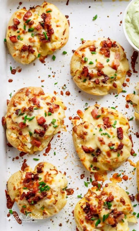 <p>Cafe Delites</p><p>Crispy and loaded cheesy bacon smashed potatoes with chives and an avocado crema!</p><p><strong>Get the recipe: <a href="https://cafedelites.com/cheesy-bacon-smashed-potatoes/" rel="nofollow noopener" target="_blank" data-ylk="slk:Cheesy Bacon Smashed Potatoes;elm:context_link;itc:0;sec:content-canvas" class="link ">Cheesy Bacon Smashed Potatoes</a></strong></p>