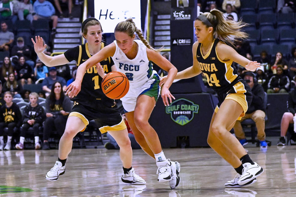 Iowa guard Molly Davis (1) and guard Gabbie Marshall (24) defend against Florida Gulf Coast guard Sofia Persson (2) during the first half of an NCAA college basketball game in Gulf Coast Showcase, Saturday, Nov. 25, in Estero, Fla. (AP Photo/Steve Nesius)