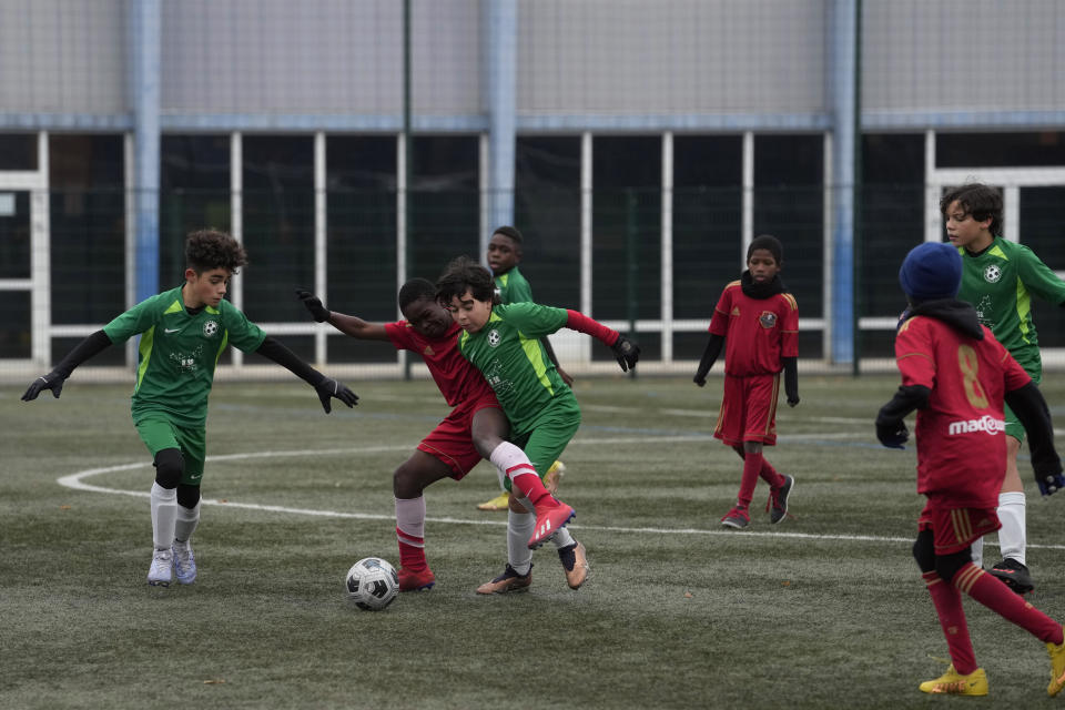 Players of the football club AS Bondy, where Kylian Mbappe played as a kid, in green, play a match on the Leo Lagrange stadium in Bondy, east of Paris, Saturday, Dec. 17, 2022. On the football fields where Kylian Mbappe hones the feints, dribbles and shots that all of France hopes to see in Sunday's World Cup final against Argentine, the next generation of French kids with big dreams is already hard at work to follow in the superstar's footsteps. (AP Photo/Thibault Camus)