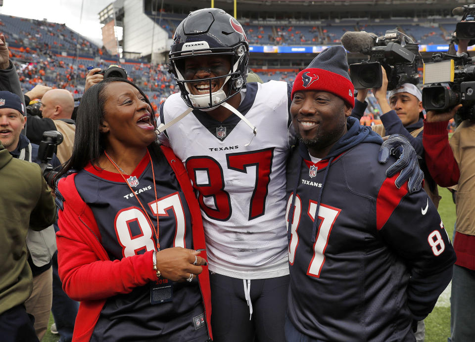 Houston Texans wide receiver Demaryius Thomas (87) stands with his parents, Bobby Thomas, right, and Katina Smith, prior to an NFL football game against the Denver Broncos, Sunday, Nov. 4, 2018, in Denver. (AP Photo/David Zalubowski)