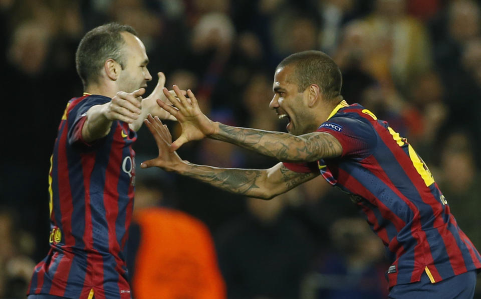 Barcelona's Daniel Alves, right celebrates with Andres Iniesta after Alves scored during a Champions League, round of 16, second leg, soccer match between FC Barcelona and Manchester City at the Camp Nou Stadium in Barcelona, Spain, Wednesday March 12, 2014. (AP Photo/Emilio Morenatti)