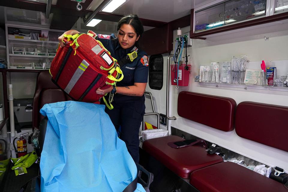 Paramedic Victoria Piedra moves a bag of medical gear in an ambulance at Georgetown Fire Station No. 5. Piedra said that whenever she is on call, she makes it a point to talk to any girl who might be staring at her. She wants to show them a woman in uniform so they can see themselves in that role.