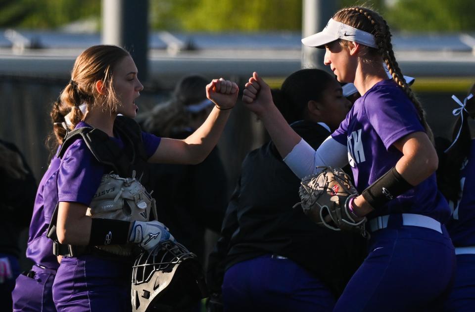 Bloomington South catcher Lindsay Blanton (left) and pitcher Kinsey Clopton celebrate between innings during the softball game against Bloomington North at South on Wednesday, April 24, 2024.