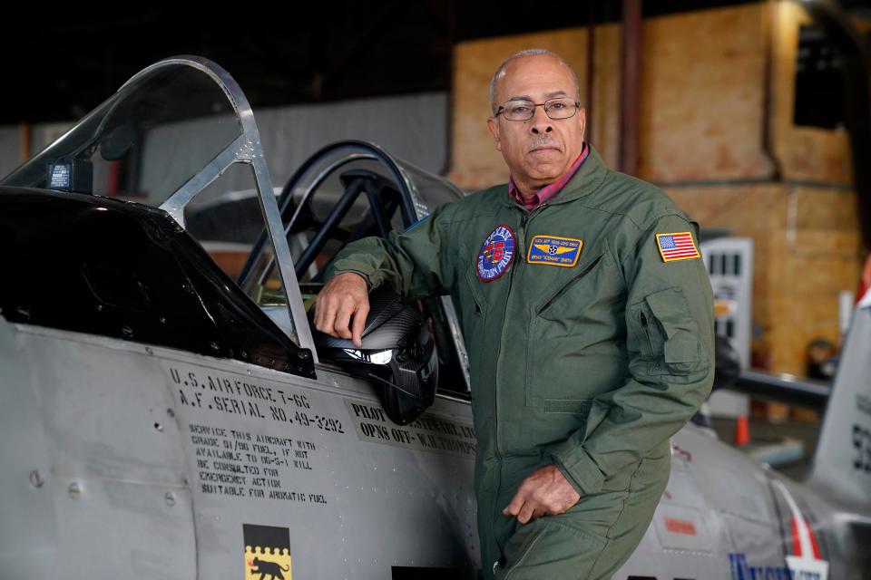 Brian Smith, President and CEO of the Tuskegee Airmen Historic Museum, stands for a photo on a T-6 Texan in a hanger at the Coleman A. Young International Airport in Detroit on Monday, Feb. 19, 2024.