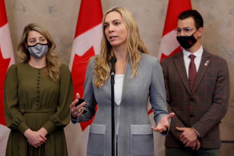 Canada's Minister of Sport Pascale St-Onge, with Minister of Foreign Affairs Melanie Joly and Parliamentary Secretary to the Minister of Sport Adam van Koeverden, speaks during a press conference on Parliament Hill in Ottawa