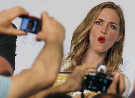 Journalists take pictures of cast member Emily Blunt as she arrives to attend a news conference for the film "Sicario" in competition at the 68th Cannes Film Festival in Cannes, southern France, May 19, 2015. REUTERS/Regis Duvignau