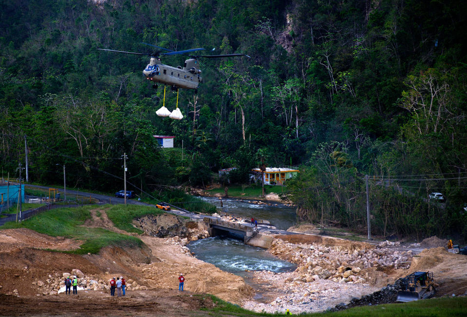 <p>A U.S. Army helicopter transports material to repair the Guajataca Dam, damaged during Hurricane Maria, in Quebradillas, Puerto Rico, Tuesday, Oct. 17, 2017. The dam was built around 1928, and holds back a man-made lake. (Photo: Ramon Espinosa/AP) </p>