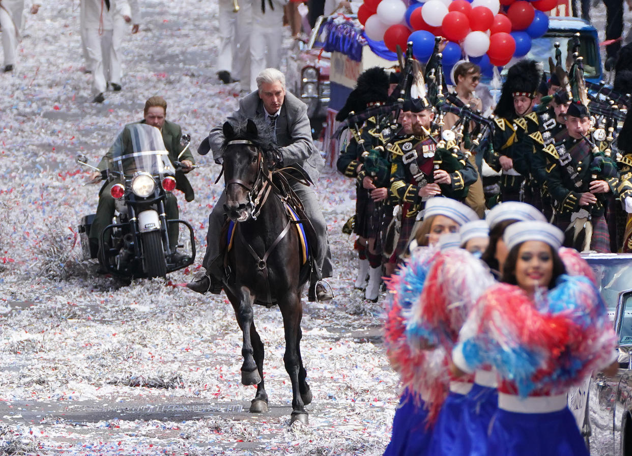 A body double for Harrison Ford and Boyd Holbrook are seen on a horse and motorbike during an Indiana Jones 5 parade scene on St Vincent Street in Glasgow city centre. (PA)