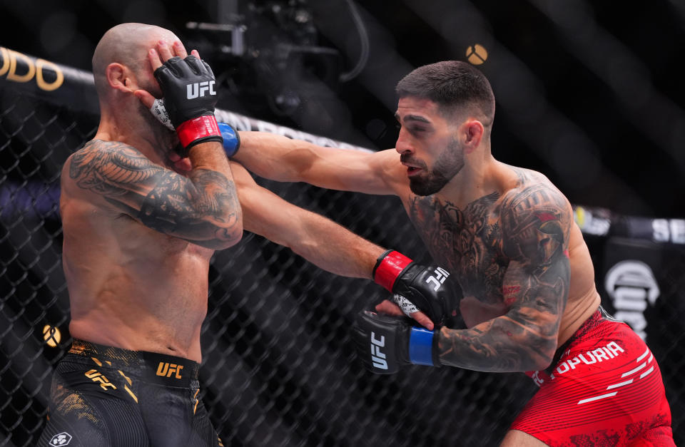 ANAHEIM, CALIFORNIA - FEBRUARY 17: (R-L) Ilia Topuria of Germany punches Alexander Volkanovski of Australia in the UFC featherweight championship fight during the UFC 298 event at Honda Center on February 17, 2024 in Anaheim, California. (Photo by Cooper Neill/Zuffa LLC via Getty Images)