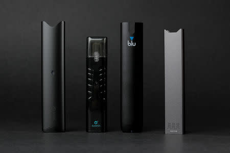 An electronic cigarette device made by JUUL (R) is shown next to other similar devices (L to R) Vuse Alto, Suorin ishare and myblu in this photo illustration taken September 20, 2018. REUTERS/Mike Blake/Illustration