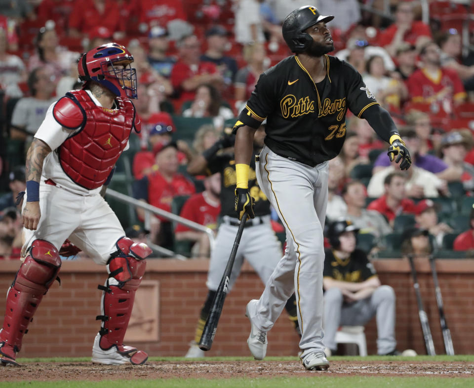 Pittsburgh Pirates' Gregory Polanco (25) watches his RBI sacrifice fly next to St. Louis Cardinals catcher Yadier Molina (4) during the sixth inning of a baseball game Friday, Aug. 20, 2021, in St. Louis. (AP Photo/Tom Gannam)