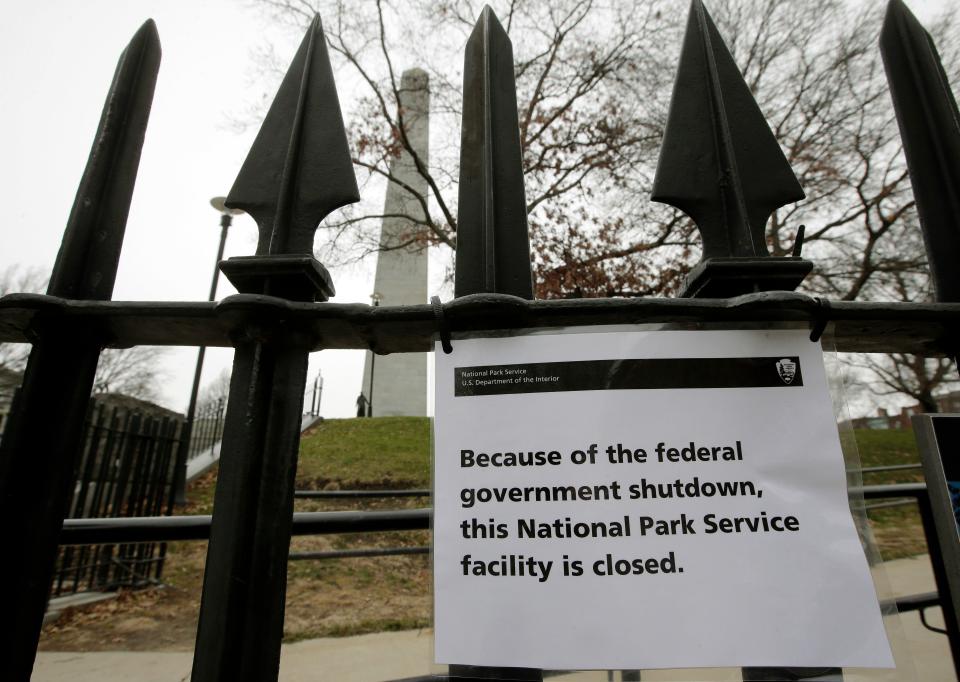 A sign is posted on a fence near an entrance to the Bunker Hill Monument, Monday, Dec. 24, 2018, in Boston. The historic site, erected to commemorate the Revolutionary War Battle of Bunker Hill, and run by the National Park Service, was closed Monday due to a partial federal government shutdown. The federal government is expected to remain partially closed past Christmas Day in a protracted standoff over President Donald Trump's demand for money to build a border wall with Mexico.