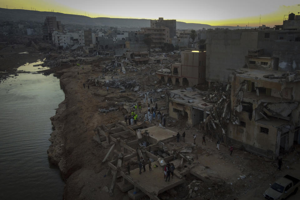 People search for flood victims in Derna, Libya, Friday, Sept. 15, 2023. Search teams are combing streets, wrecked buildings, and even the sea to look for bodies in Derna, where the collapse of two dams unleashed a massive flash flood that killed thousands of people. (AP Photo/Ricardo Garcia Vilanova)