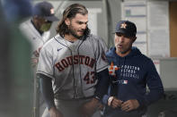 Houston Astros starting pitcher Lance McCullers Jr., left, walks in the dugout after finishing the sixth inning of the team's baseball game against the Seattle Mariners, Tuesday, July 27, 2021, in Seattle. (AP Photo/Ted S. Warren)