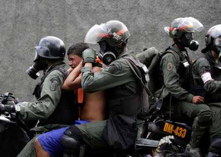 An opposition supporter is detained by riot police during a rally against Venezuela's President Nicolas Maduro in Caracas, Venezuela, April 26, 2017. REUTERS/Marco Bello