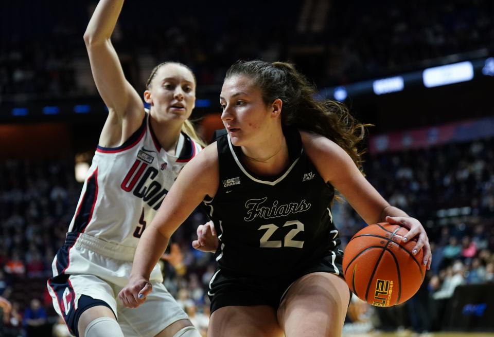 Providence guard Brynn Farrell drives with the ball against UConn guard Paige Bueckers during the second half at Mohegan Sun Arena on March 9.