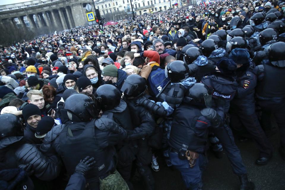 FILE - In this Jan. 23, 2021, file photo, people in St. Petersburg, Russia, clash with police while protesting the jailing of opposition leader Alexei Navalny. Rattled by the nationwide demonstrations in support of the Kremlin foe, authorities are moving rapidly to block any new ones – from piling legal pressure on his allies to launching a campaign to discredit the demonstrations. (AP Photo/Dmitri Lovetsky, File)