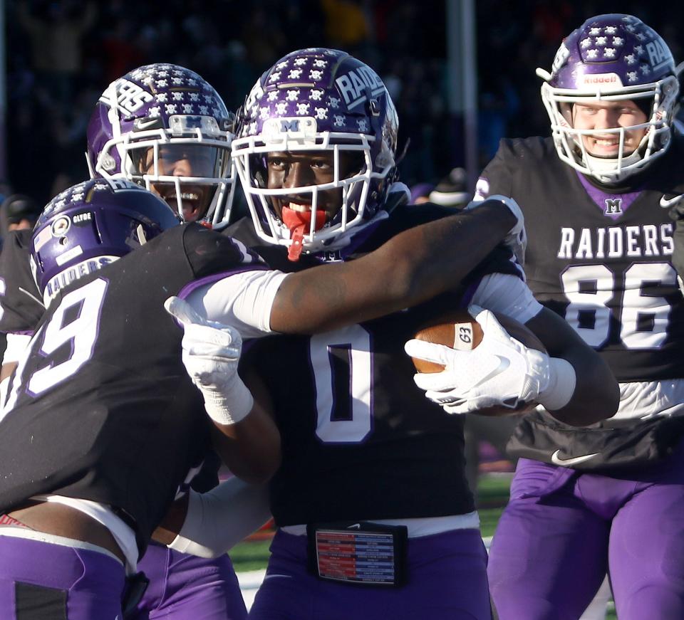 Mount Union teammates surround wide receiver Derrick Harvey, Jr. (0) after his game-winning catch in overtime from Braxton Plunk during their quarterfinal playoff game against Muhlenberg, Saturday, December 4, 2021.