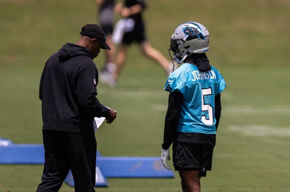 Carolina Panthers Diontae Johnson, right, talks to a coach at practice in Charlotte, N.C., on Monday, May 20, 2024.