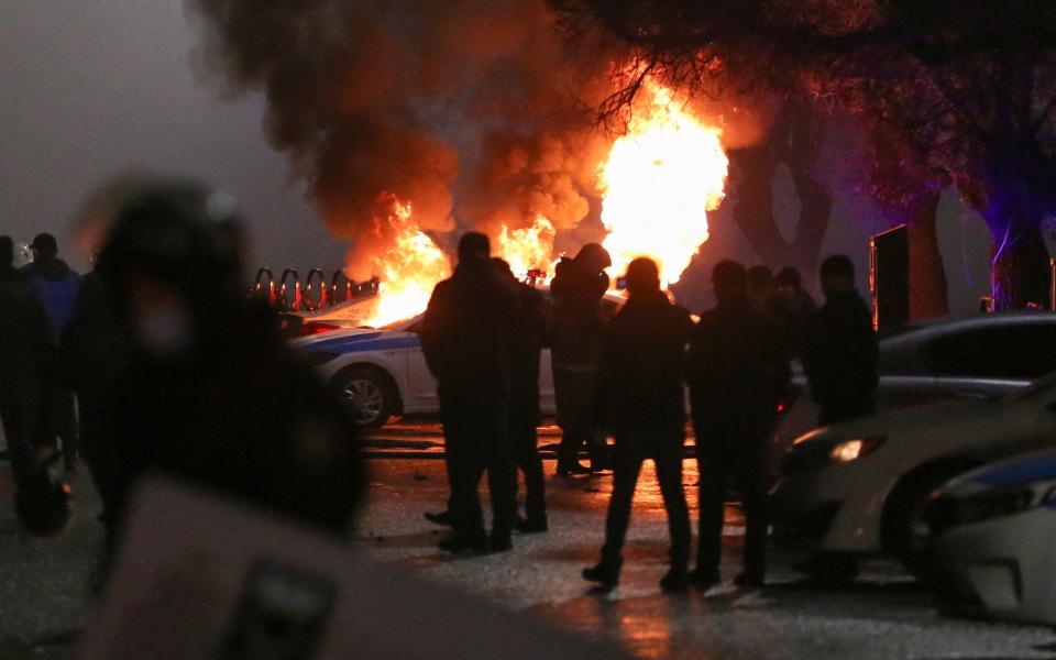 Rioters burned a police car during the protests in Kazakhstan - PAVEL MIKHEYEV /Reuters
