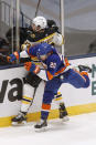 Boston Bruins' Charlie McAvoy (73) and New York Islanders' Kieffer Bellows (20) collide during the second period of an NHL hockey game Monday, Jan. 18, 2021, in Uniondale, N.Y. (AP Photo/Jason DeCrow)